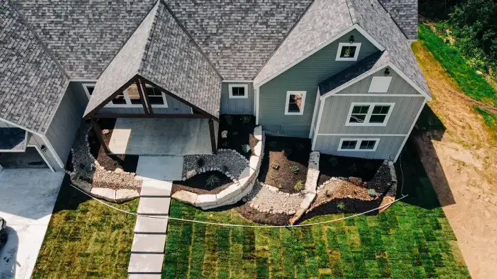 Aerial view of a home surrounded by mature trees